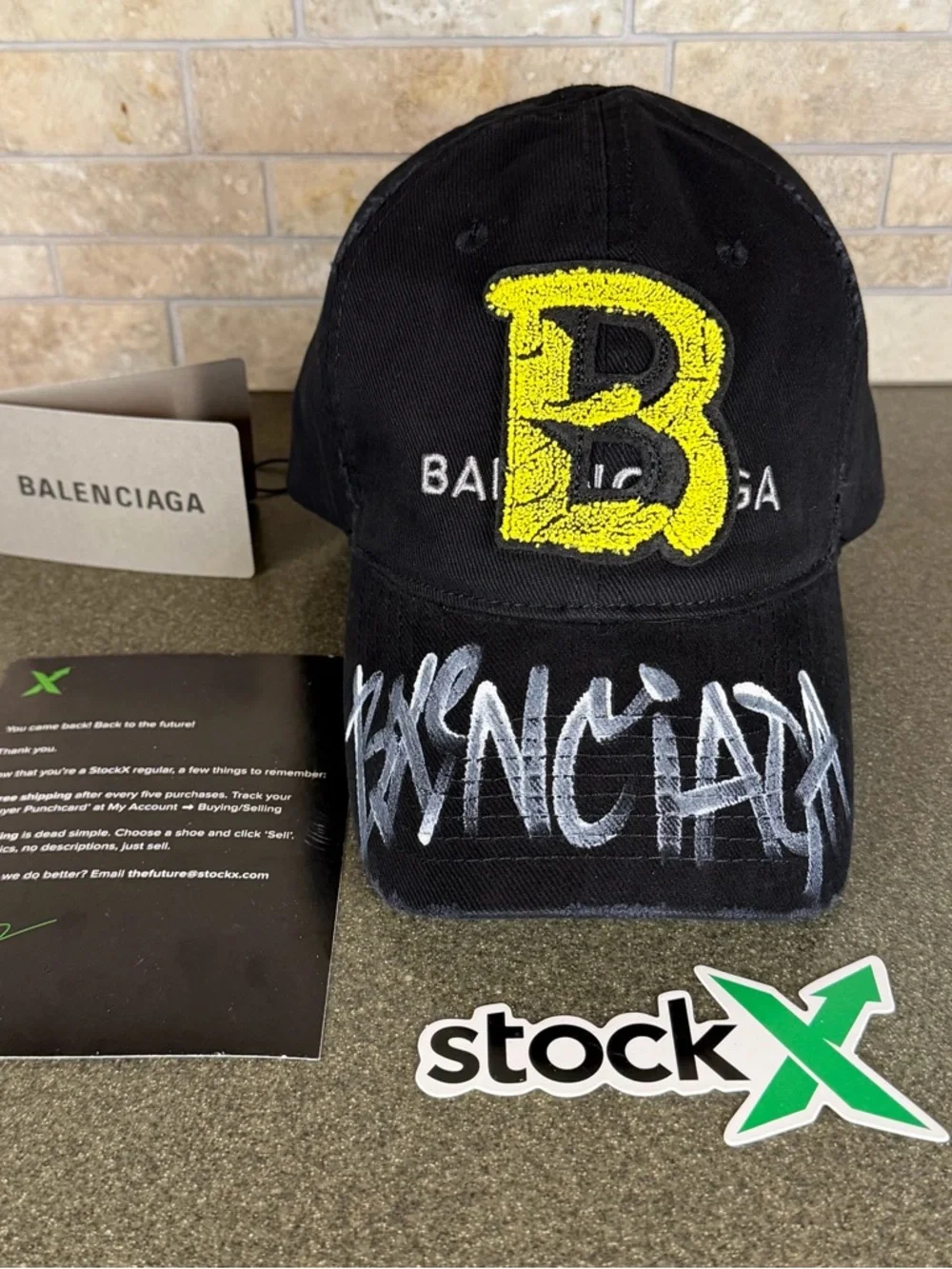 Balenciaga Black Cap with Yellow 'B' Patch and White Graffiti - Picture 1 of 4